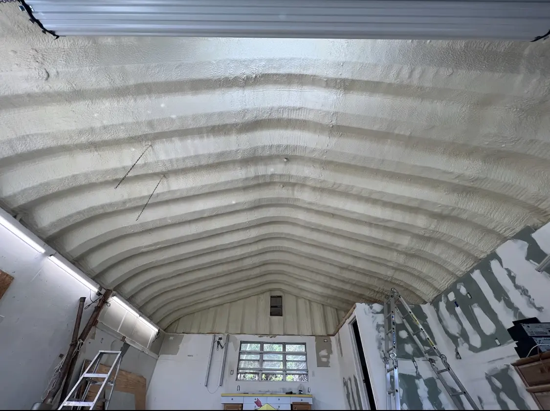 Spray polyurethane foam applied to the underside of a metal roof deck in Hendersonville